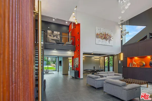 a living room with furniture a window and a flat screen tv