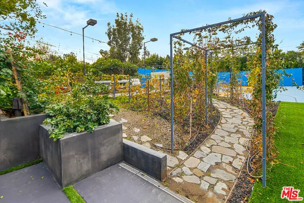 a view of a swimming pool with sitting area in front of it