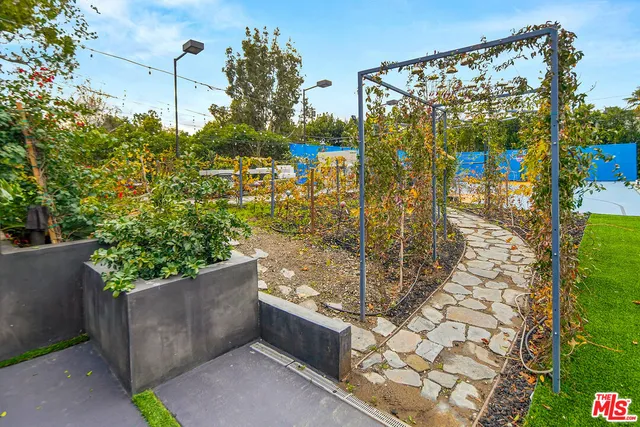 a view of a swimming pool with sitting area in front of it