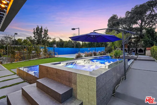 a view of a house with swimming pool in front of house