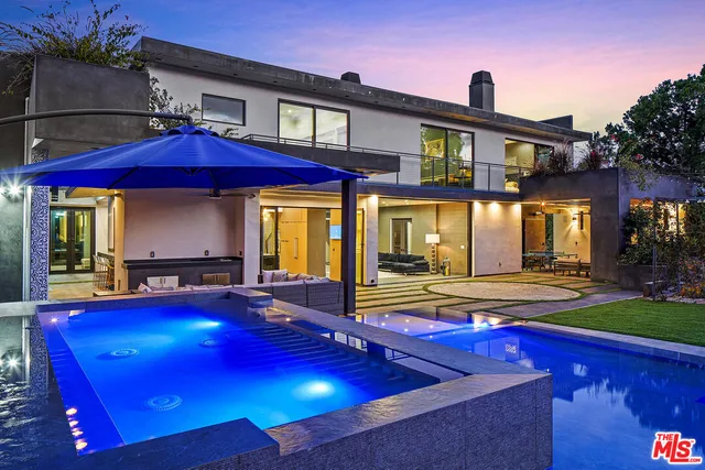 a room with furniture pool table and windows