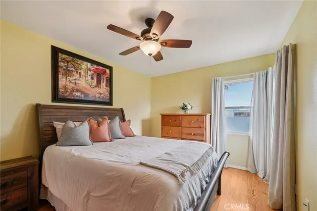 a bedroom with a large bed and a chandelier