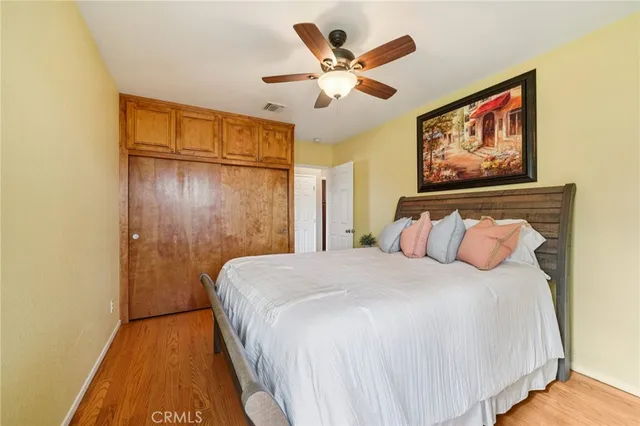 a bedroom with a large bed and a chandelier