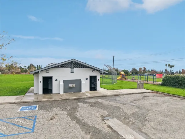 a view of a house with a yard and potted plants