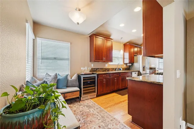 a kitchen with stainless steel appliances granite countertop sink stove and cabinets