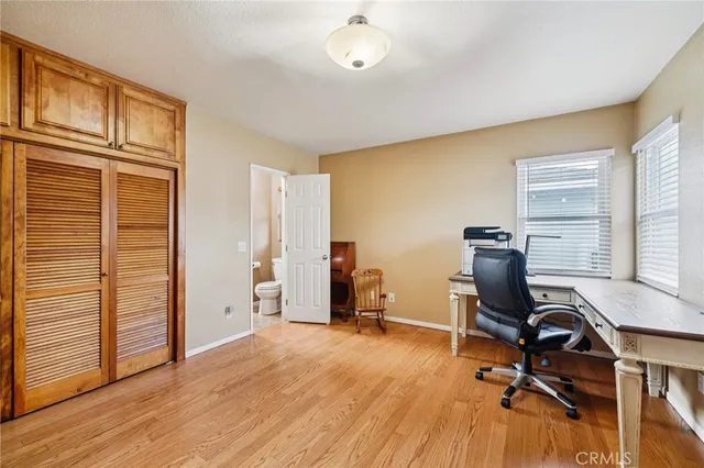 a view of a workspace with furniture and a window