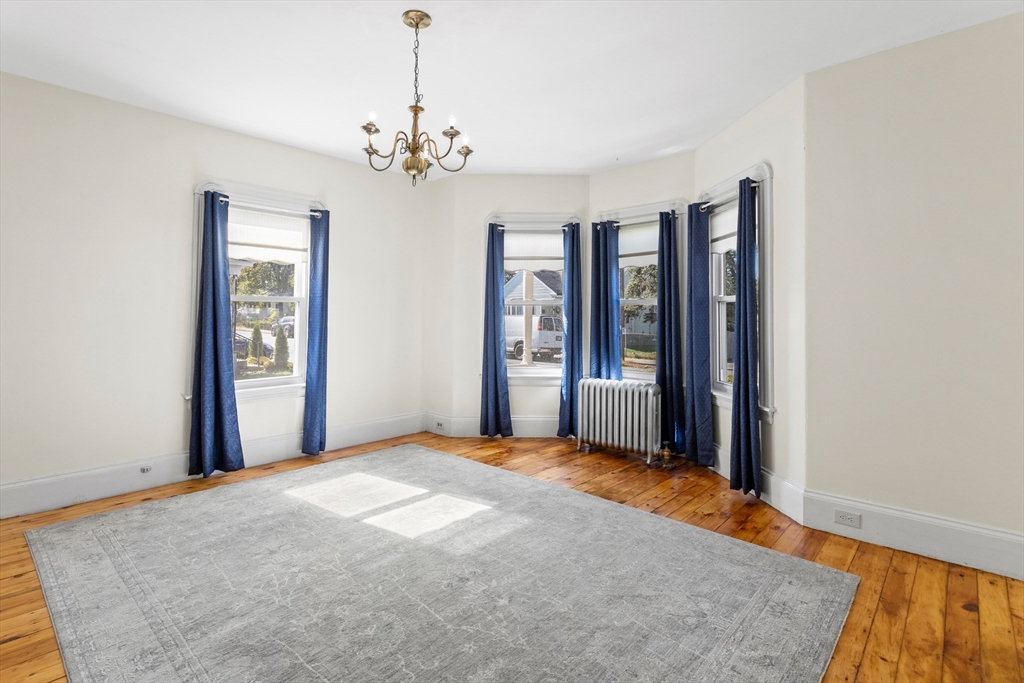 6 Barker Street Methuen, MA 01844 - Photo 11 of 42 a view of an empty room with chandelier and a window
