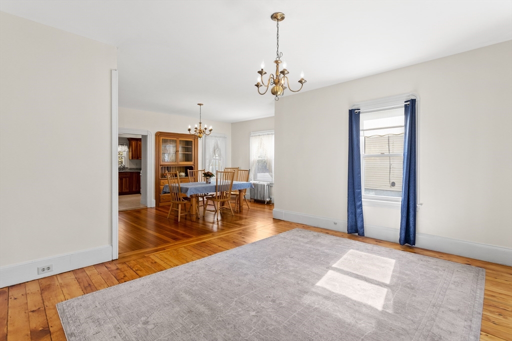 6 Barker Street Methuen, MA 01844 - Photo 12 of 42 a view of a livingroom with a dinning area hardwood floor and a chandelier