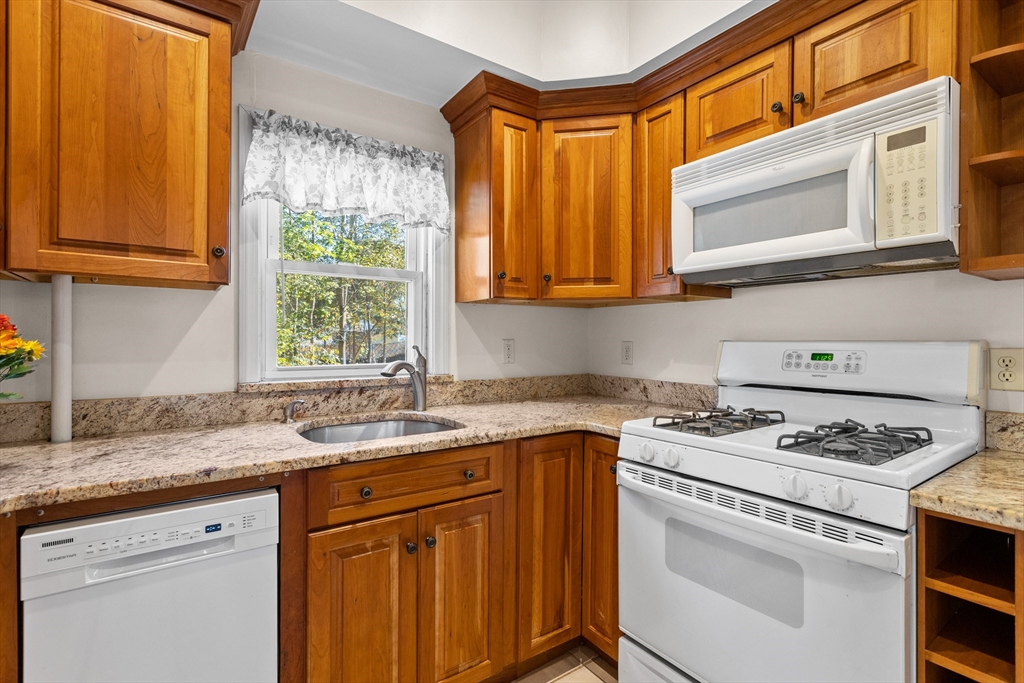 6 Barker Street Methuen, MA 01844 - Photo 18 of 42 a kitchen with granite countertop cabinets stainless steel appliances a sink and a window