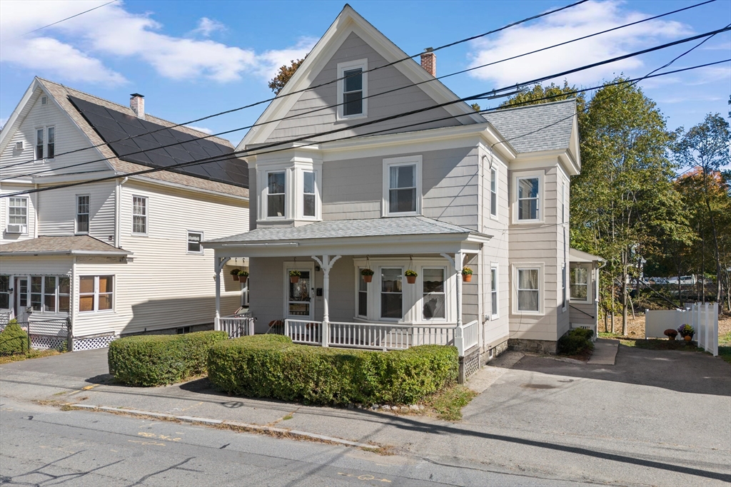 6 Barker Street Methuen, MA 01844 - Photo 40 of 42 a view of a white house with large windows and a small yard
