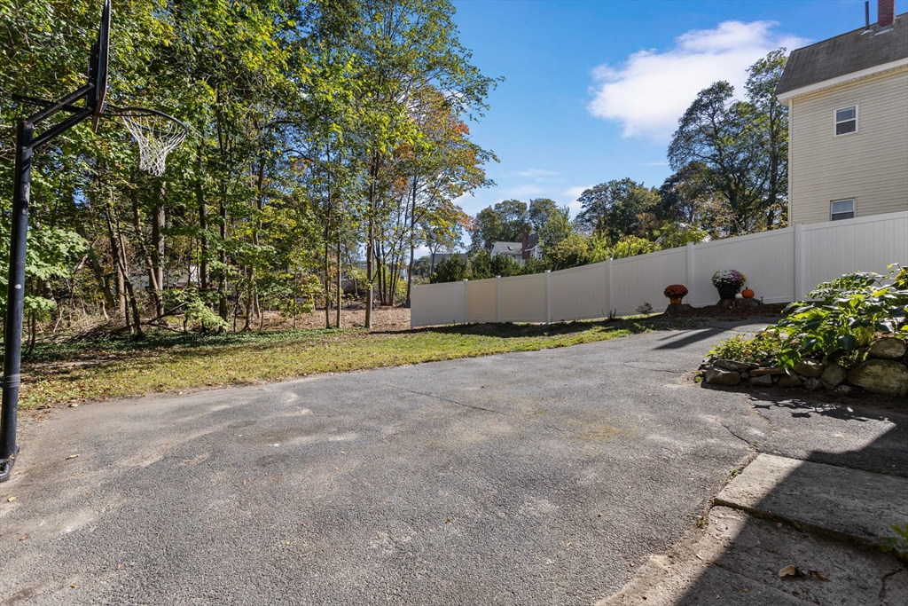 6 Barker Street Methuen, MA 01844 - Photo 6 of 42 a view of a house with a big yard and large trees
