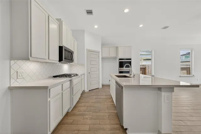 a kitchen with sink and microwave