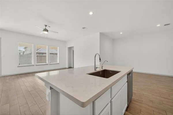a large kitchen with kitchen island a sink stainless steel appliances and cabinets
