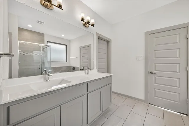 a spacious bathroom with a bathtub shower sink and mirror