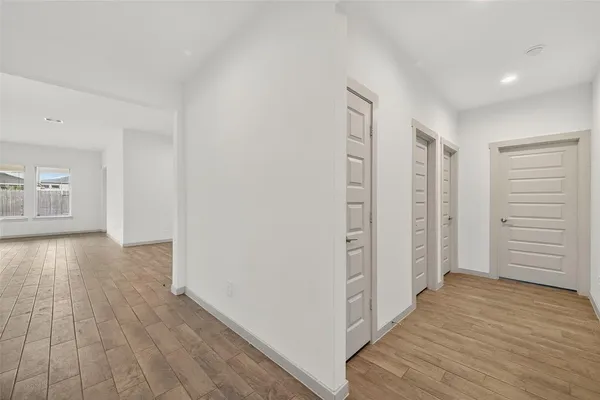 a view of an empty room with wooden floor