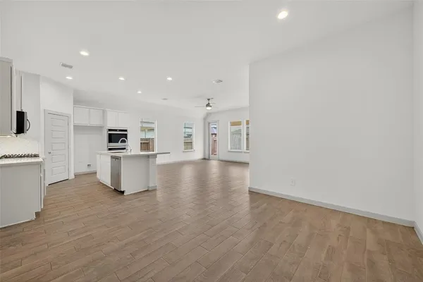 a view of kitchen with wooden floor and electronic appliances
