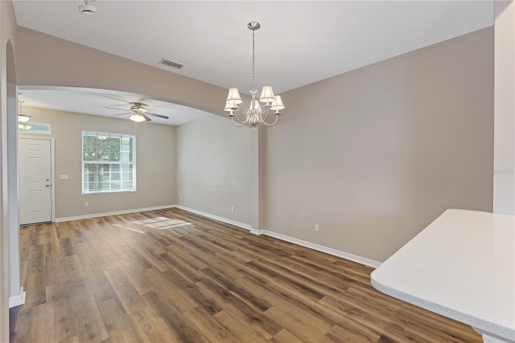 506 Rainbow Springs Loop Groveland, FL 34736 - Photo 6 of 30 a view of a room with wooden floor and chandelier