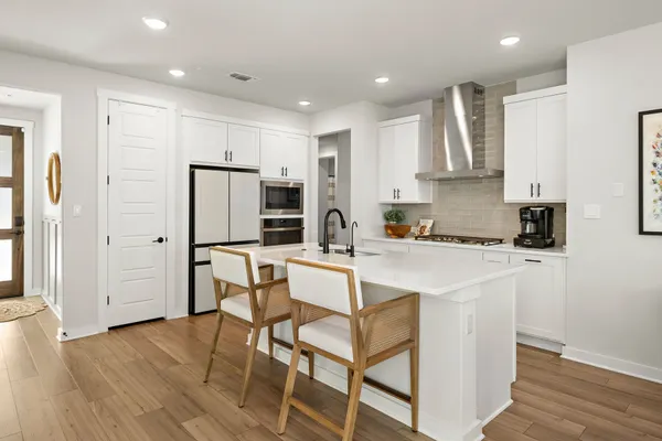 a kitchen with a sink a stove and cabinets