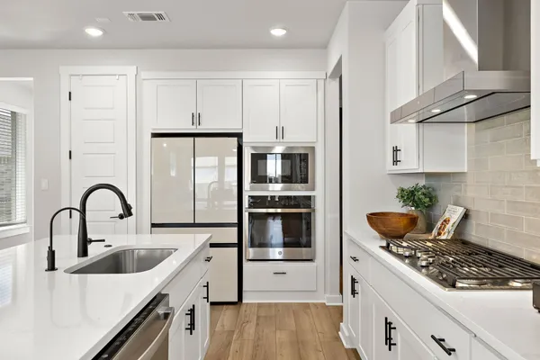 a large white kitchen with a large window