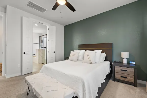 a bedroom with a bed and a flat screen tv