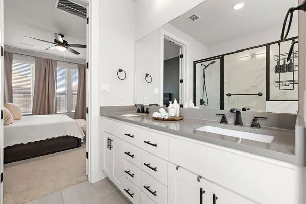 a bathroom with a granite countertop sink mirror and shower