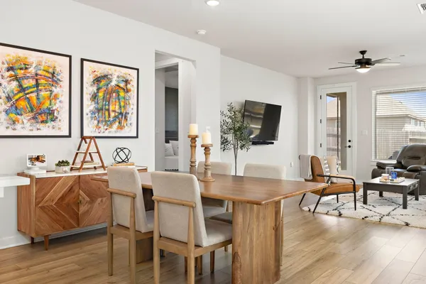 a view of a dining room with furniture and wooden floor