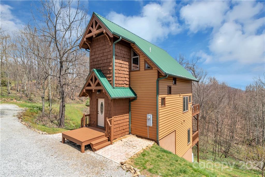 2794 Utah Mountain Road Waynesville, NC 28785 - Photo 1 of 27 a front view of a house with wooden fence