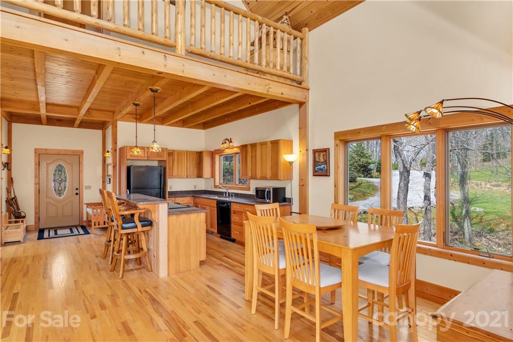 2794 Utah Mountain Road Waynesville, NC 28785 - Photo 11 of 27 a view of a dining room with furniture window and wooden floor