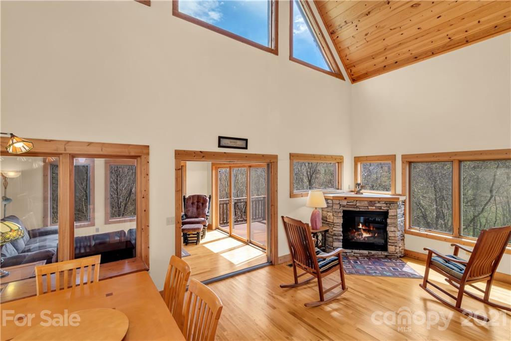 2794 Utah Mountain Road Waynesville, NC 28785 - Photo 12 of 27 a living room with furniture a fireplace and a table