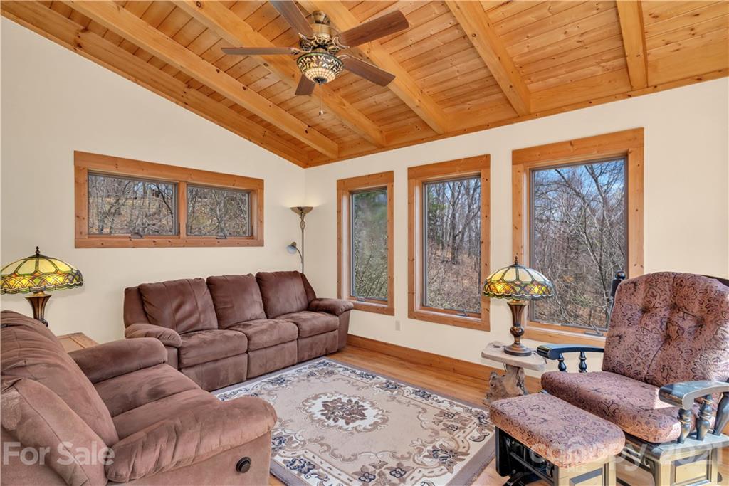 2794 Utah Mountain Road Waynesville, NC 28785 - Photo 15 of 27 a living room with furniture and a large window