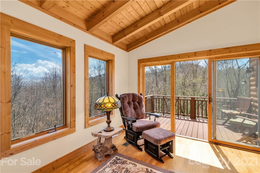 2794 Utah Mountain Road Waynesville, NC 28785 - Photo 16 of 27 a living room with furniture and a floor to ceiling window