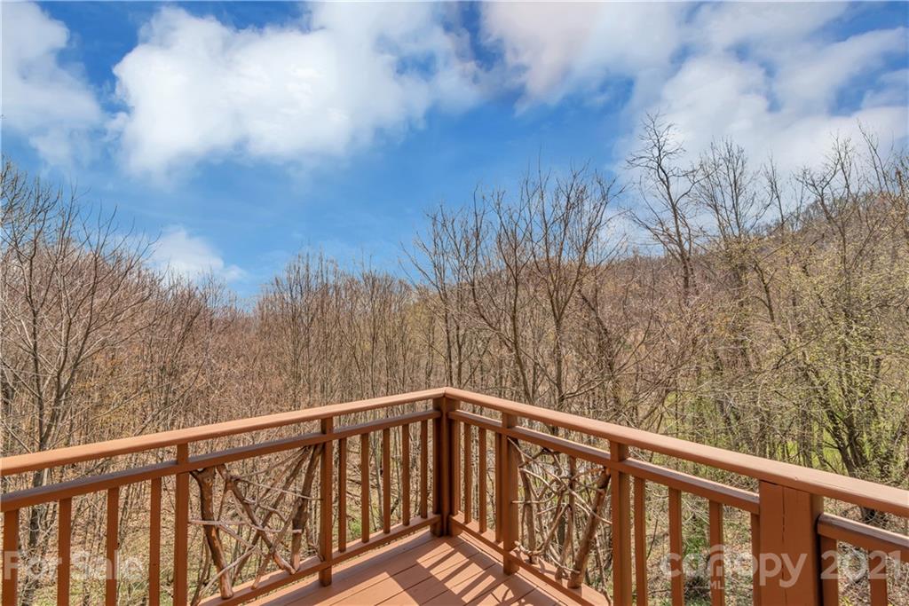 2794 Utah Mountain Road Waynesville, NC 28785 - Photo 17 of 27 a balcony with trees in the background