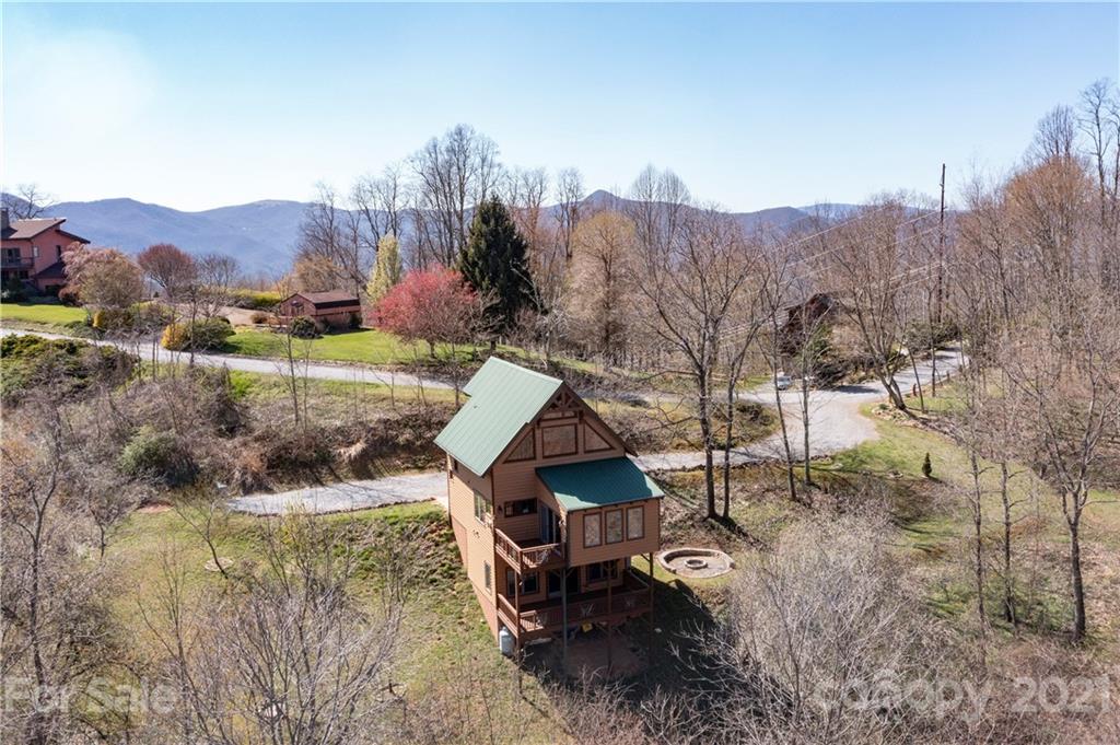 2794 Utah Mountain Road Waynesville, NC 28785 - Photo 3 of 27 a view of a house with a mountain and a yard