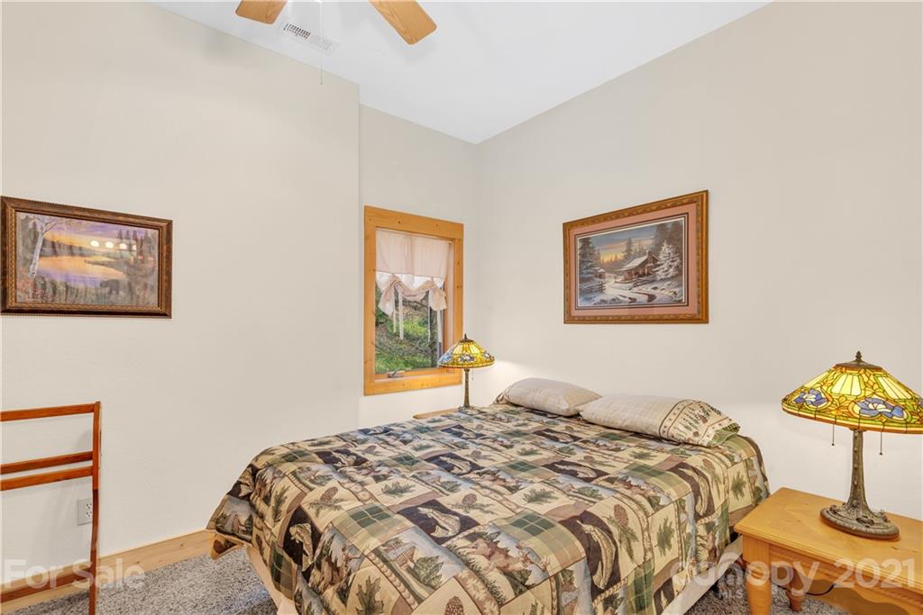 2794 Utah Mountain Road Waynesville, NC 28785 - Photo 21 of 27 a bedroom with a bed and painting on the wall