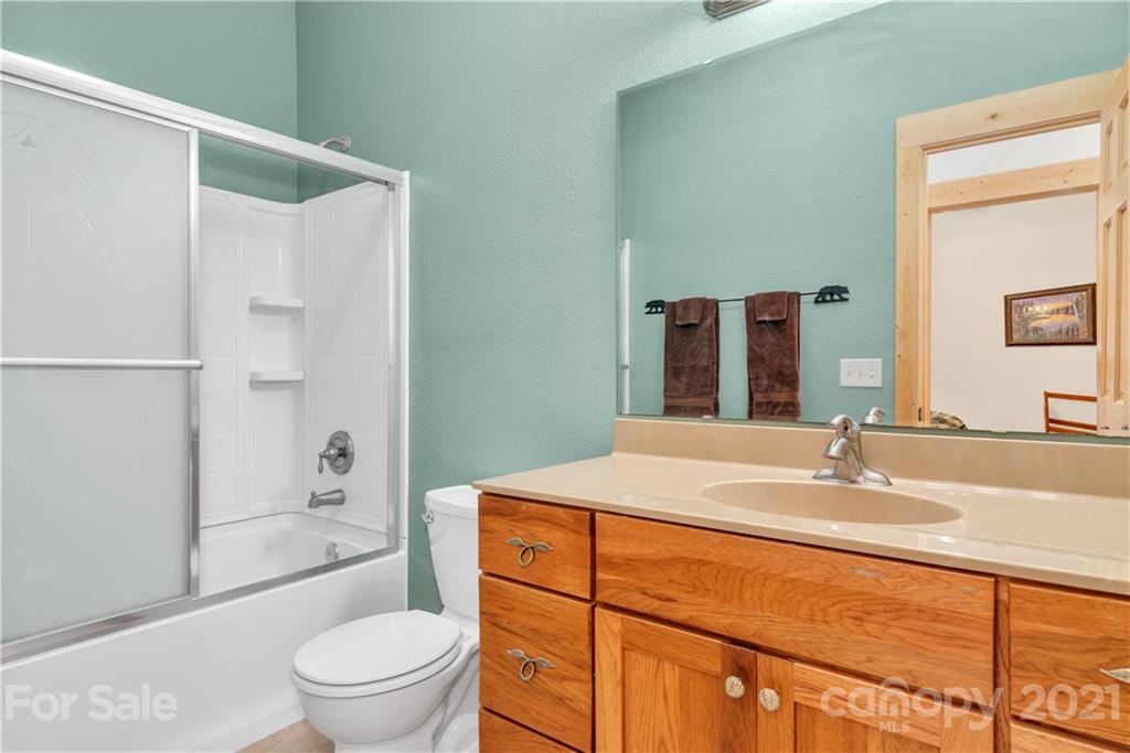 2794 Utah Mountain Road Waynesville, NC 28785 - Photo 22 of 27 a bathroom with a sink toilet vanity and shower