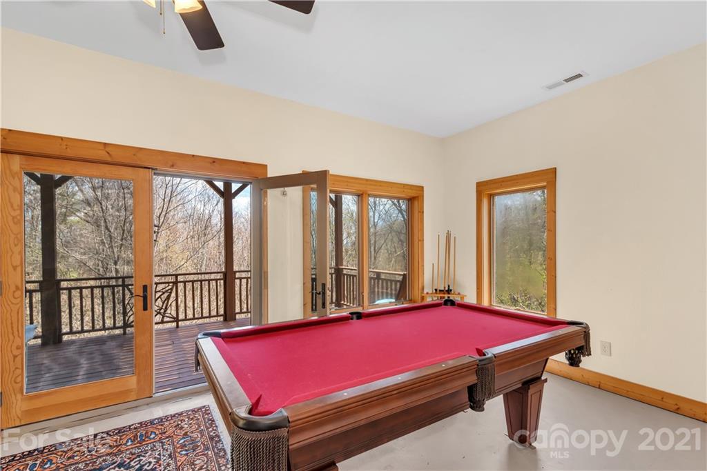 2794 Utah Mountain Road Waynesville, NC 28785 - Photo 24 of 27 a room with pool table and windows