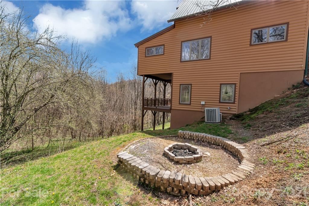 2794 Utah Mountain Road Waynesville, NC 28785 - Photo 27 of 27 a view of a house with brick walls