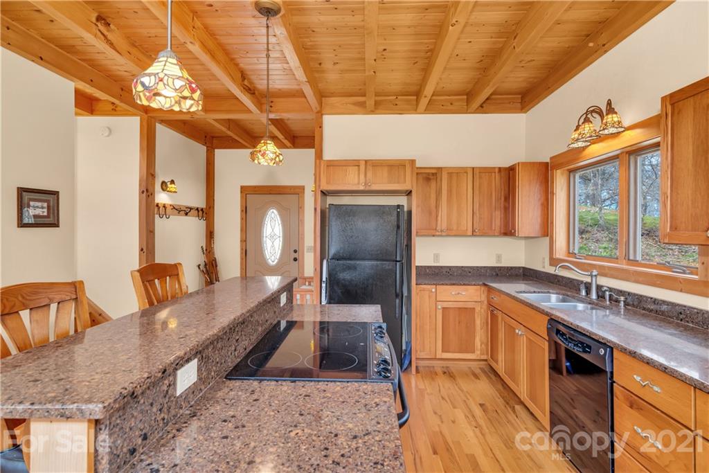 2794 Utah Mountain Road Waynesville, NC 28785 - Photo 7 of 27 a large kitchen with stainless steel appliances granite countertop a sink and cabinets