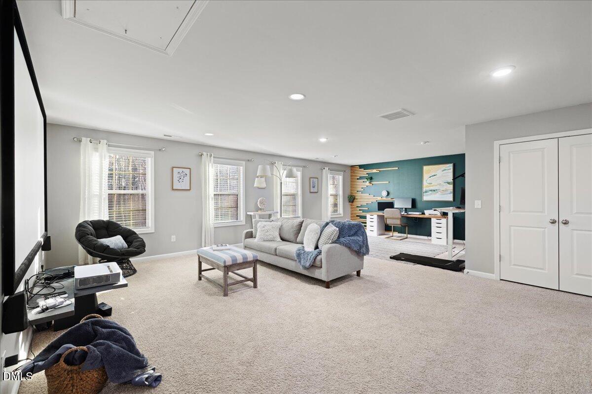 7804 Charters End Street Willow Spring, NC 27592 - Photo 22 of 43 a living room with furniture and a large window