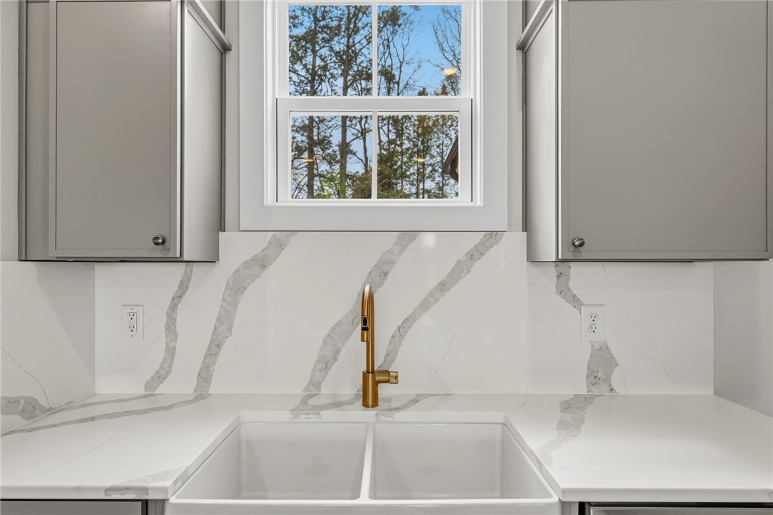 319 Summerall Drive Anderson, SC 29621 - Photo 12 of 37 This kitchen showcases a modern sink with a sleek faucet and elegant countertops.