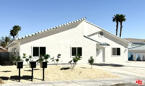 a view of a patio with a table and chairs