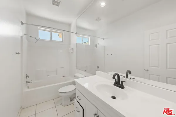 a bathroom with a sink toilet tub and shower