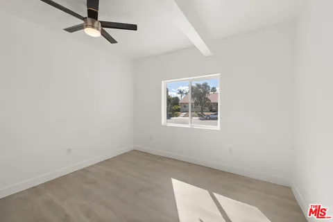 a view of a kitchen with a sink and a refrigerator