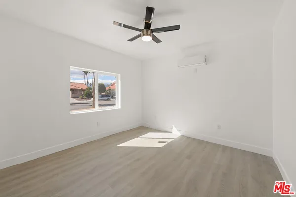 a kitchen with stainless steel appliances granite countertop a stove top oven a sink and a refrigerator