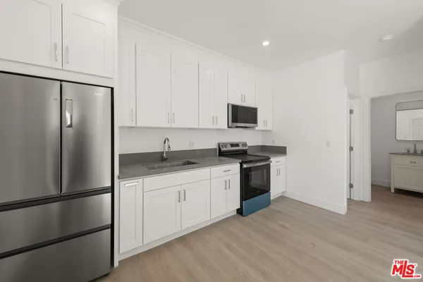 an empty room with a window and ceiling fan