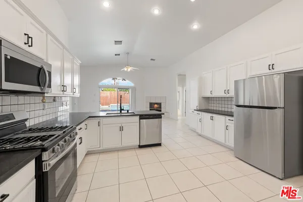 a kitchen with a stove a sink and a refrigerator