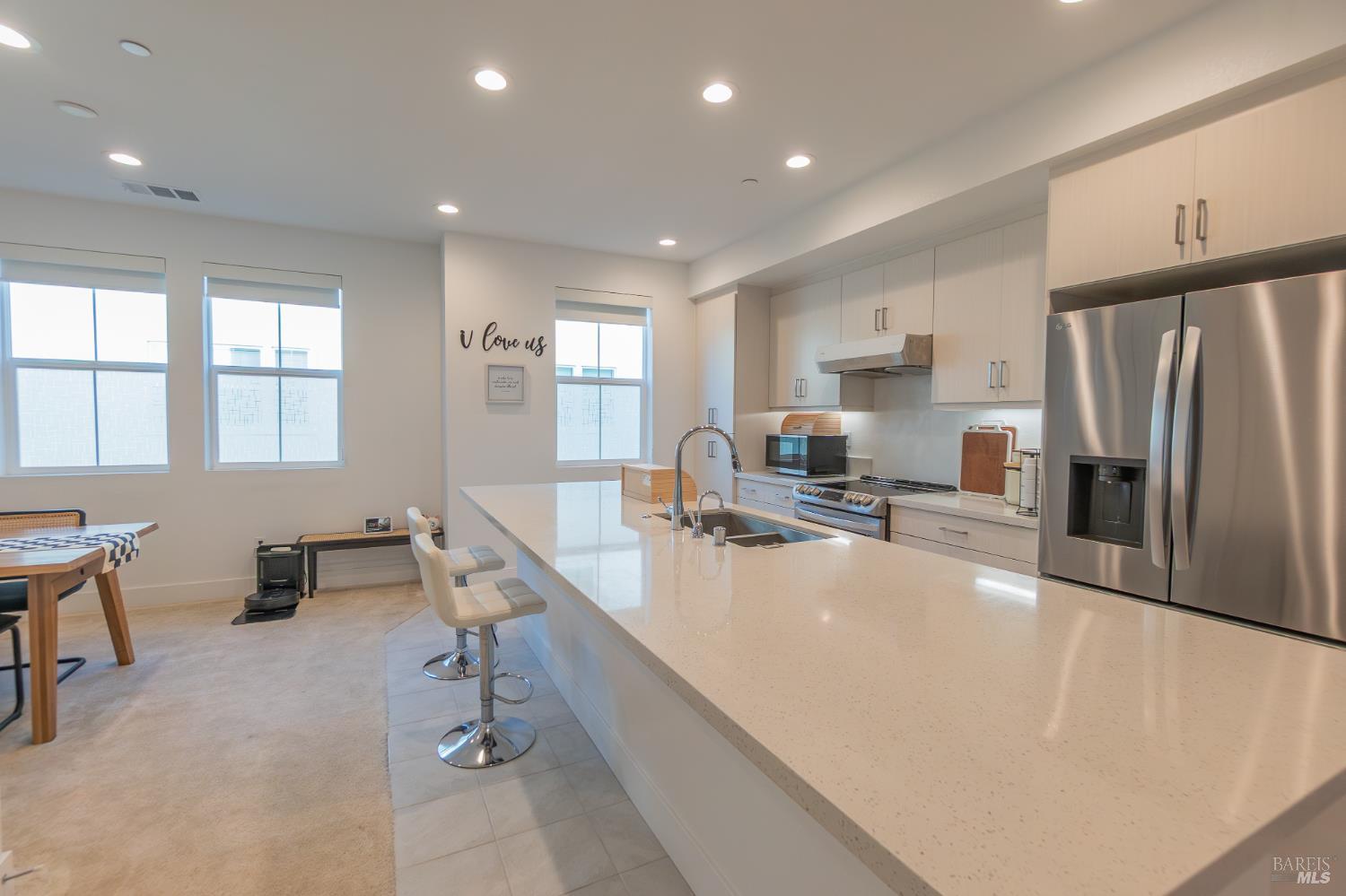 306 Rockview Road Novato, CA 94949 - Photo 12 of 37 a large kitchen with kitchen island a large counter top stainless steel appliances a sink a window and cabinets
