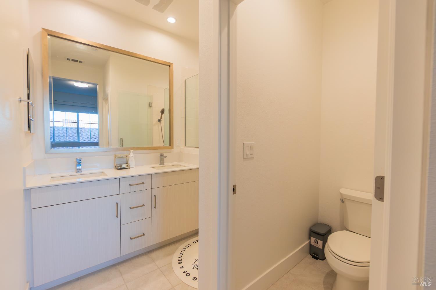306 Rockview Road Novato, CA 94949 - Photo 24 of 37 a bathroom with a toilet a sink a mirror a vanity and window