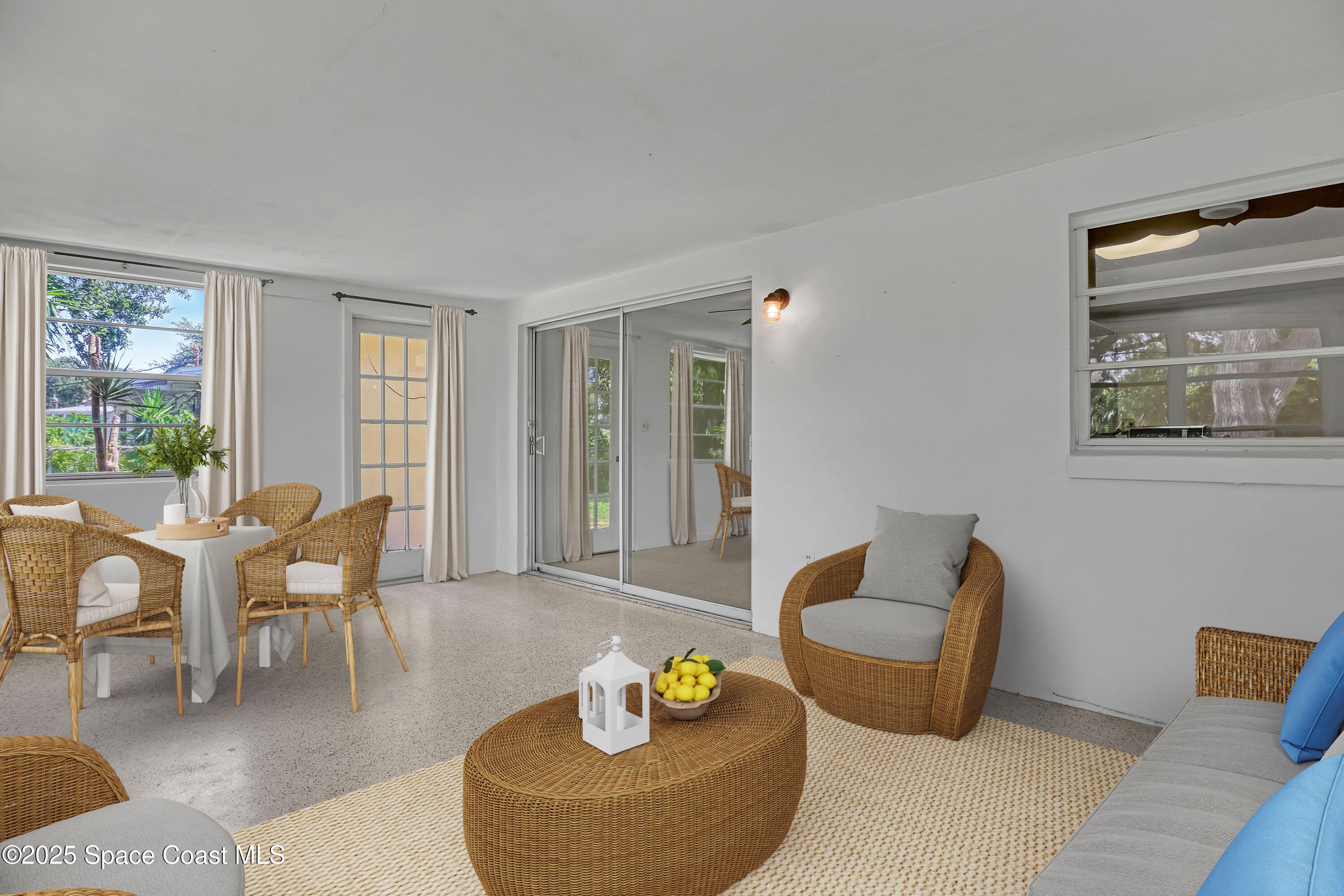 955 Samar Road Cocoa Beach, FL 32931 - Photo 16 of 37 a living room with furniture and floor to ceiling windows