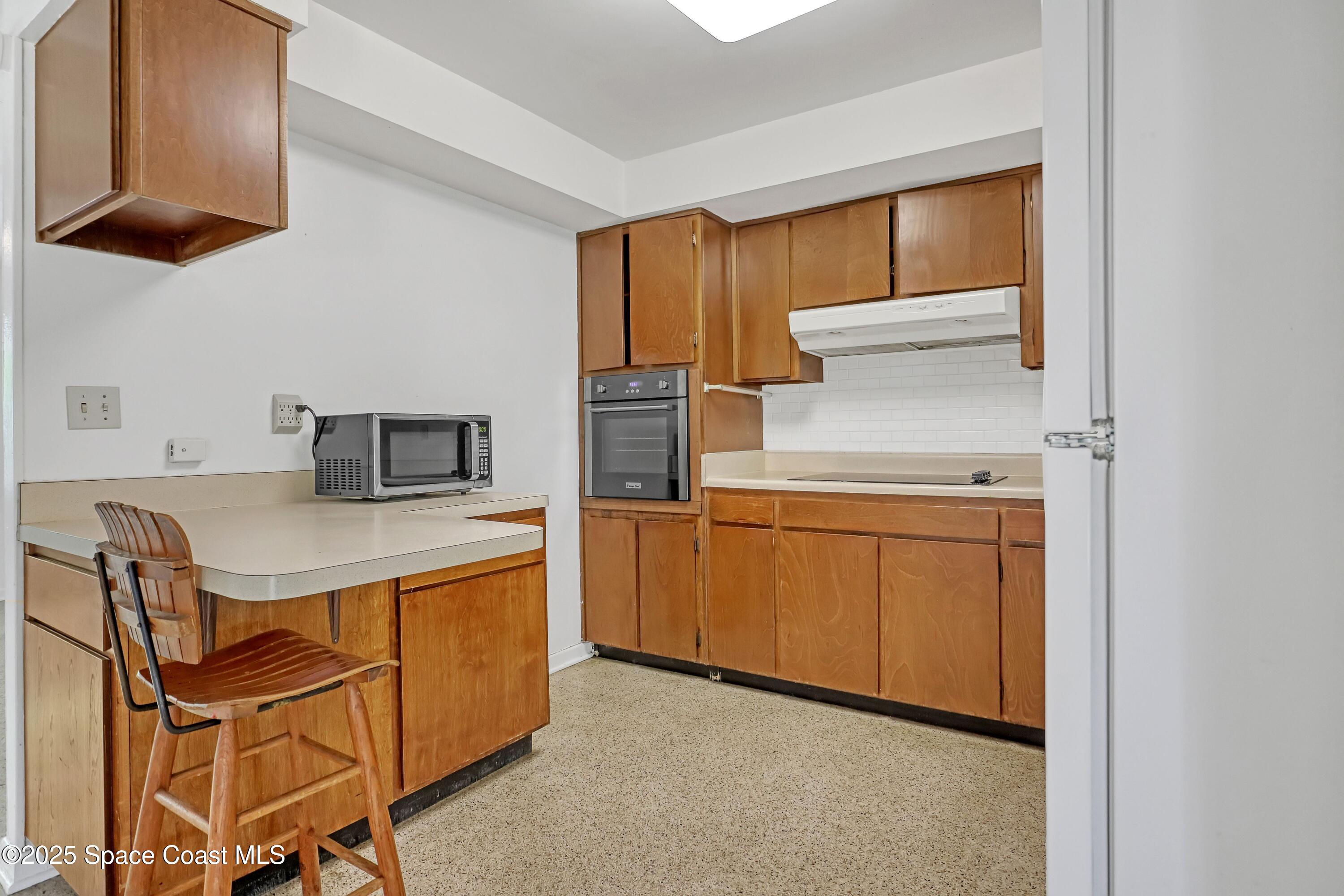 955 Samar Road Cocoa Beach, FL 32931 - Photo 19 of 37 a kitchen that has a sink and a stove